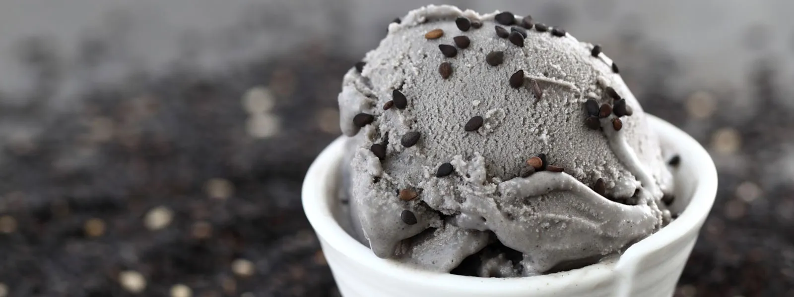 A scoop of gelato in a white cup