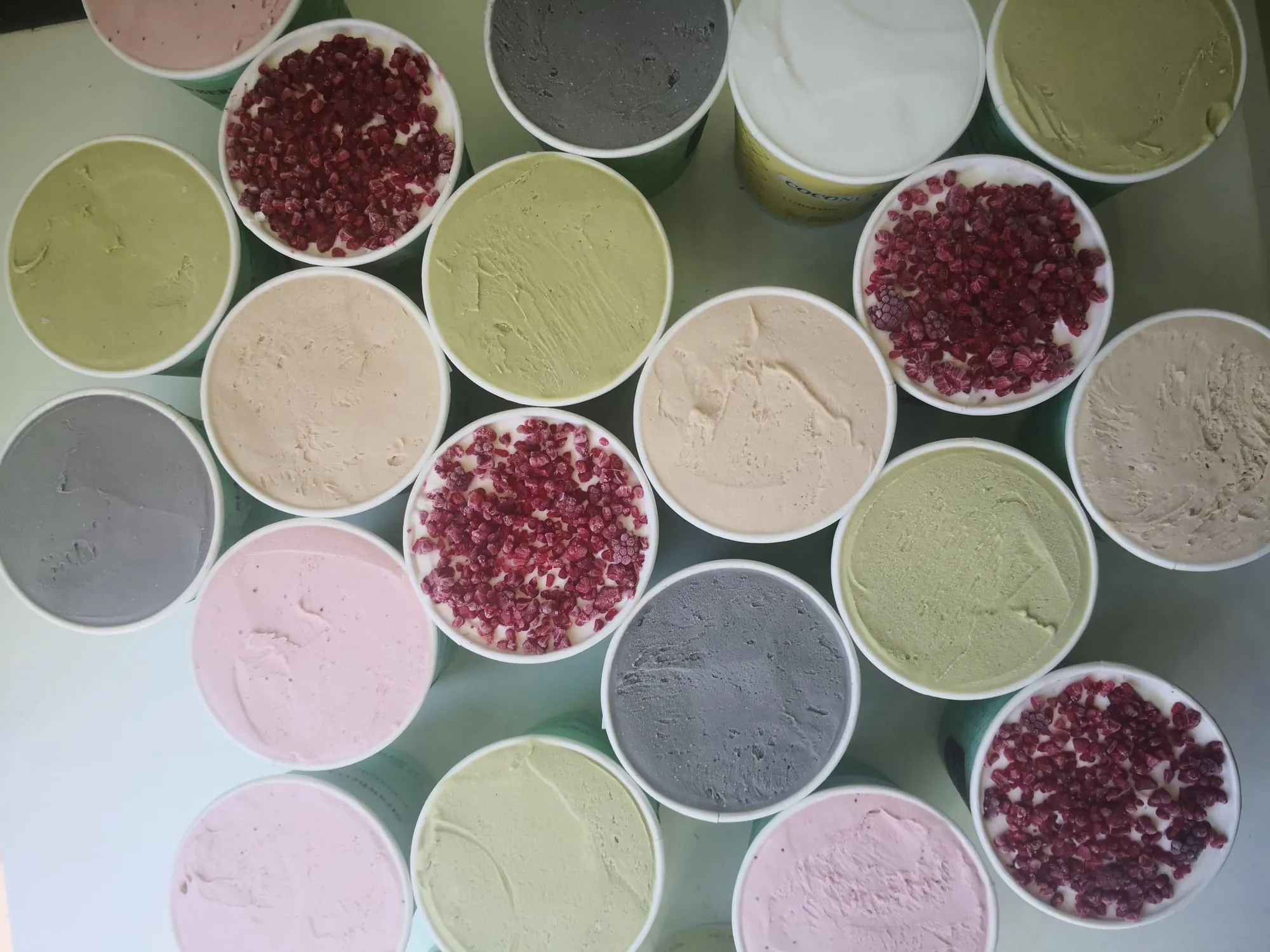 Tubs of gelato in many flavours, seen from above